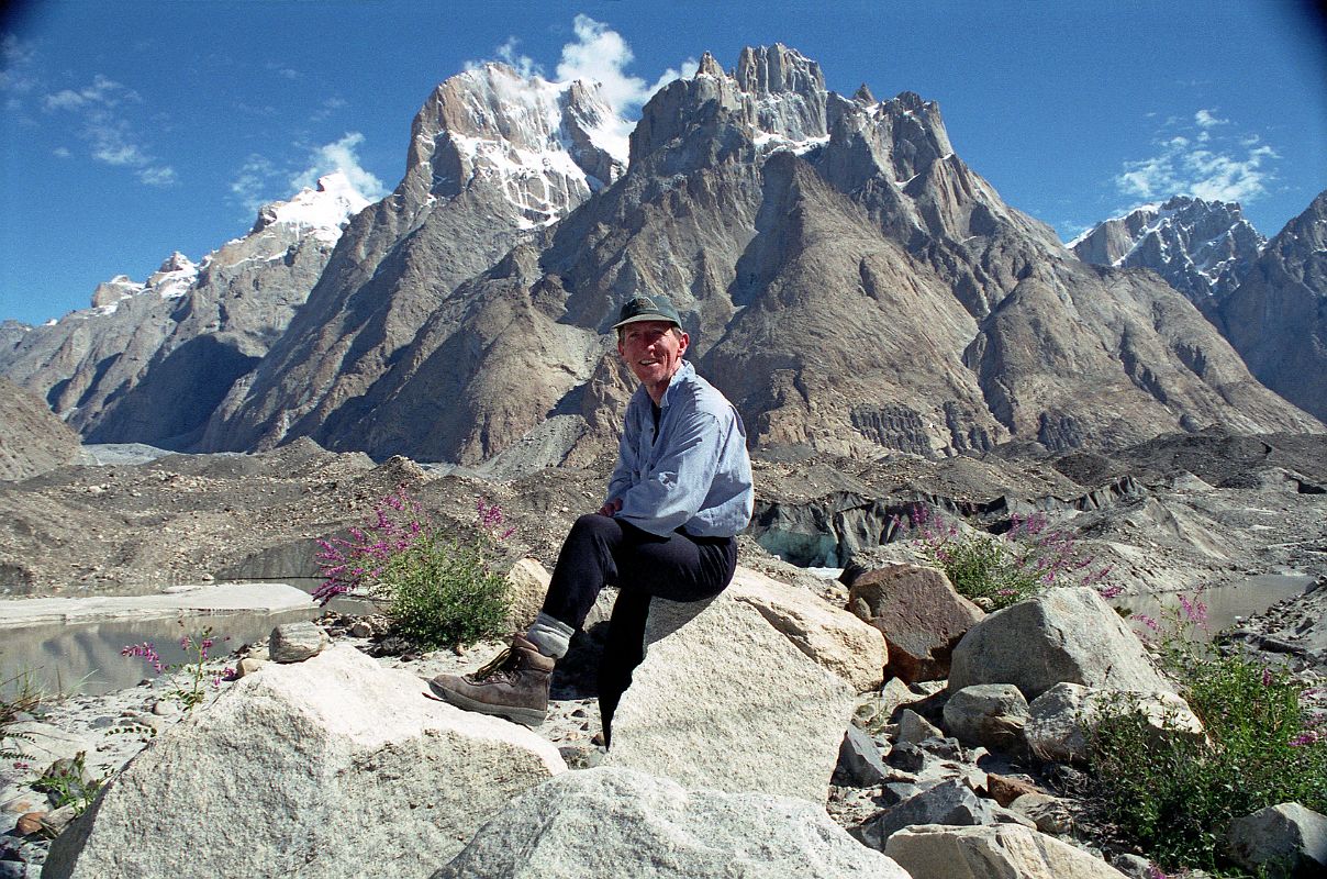 18 Jerome Ryan Poses Above Lake On Baltoro Glacier With Great Trango Tower And Trango Castle Behind